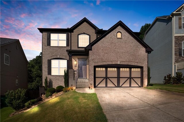 view of front of property featuring a lawn and a garage