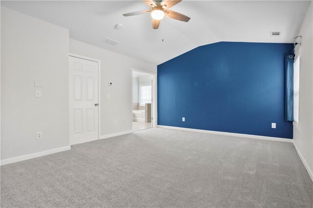 spare room with carpet flooring, ceiling fan, and lofted ceiling