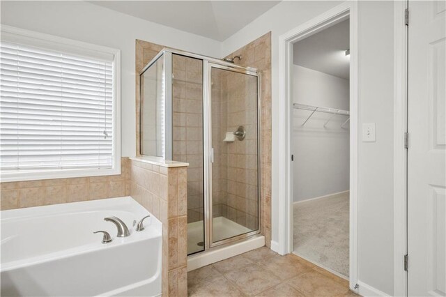 bathroom featuring tile patterned floors, plenty of natural light, and independent shower and bath