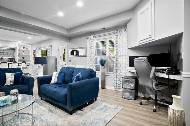 living room featuring light hardwood / wood-style flooring and built in features