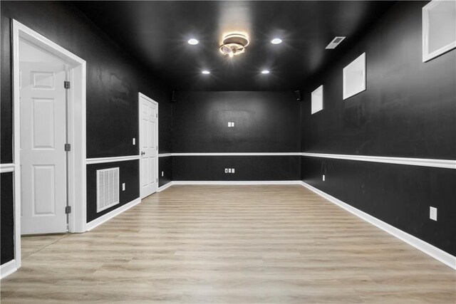 unfurnished room featuring light hardwood / wood-style floors and basketball court