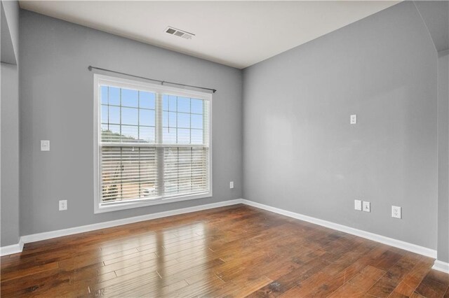 spare room featuring dark hardwood / wood-style flooring