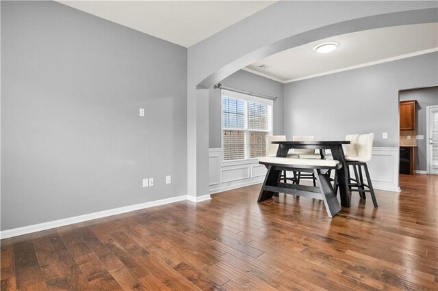 dining room with wood-type flooring and ornamental molding