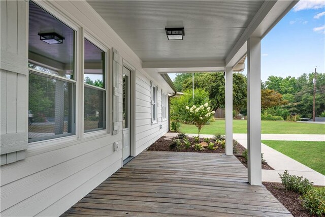 wooden deck with a lawn