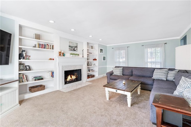 living room featuring light carpet, crown molding, a high end fireplace, and built in shelves