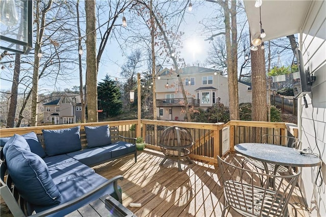 wooden terrace with an outdoor hangout area