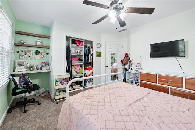 bedroom featuring light colored carpet, a closet, and ceiling fan