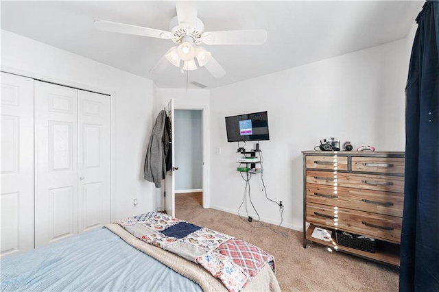 carpeted bedroom featuring a closet and ceiling fan