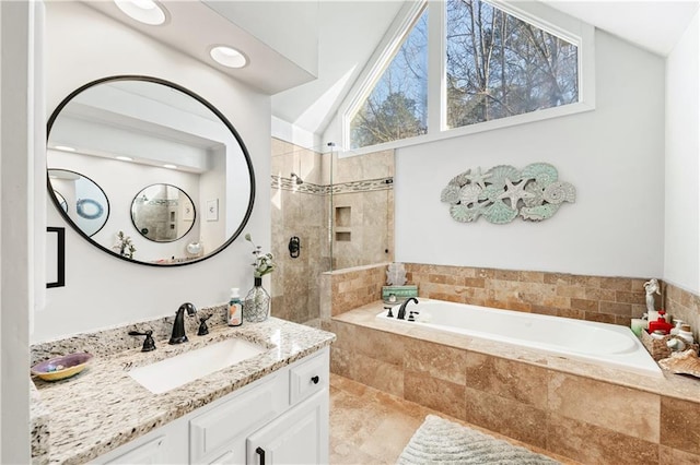 bathroom with independent shower and bath, vaulted ceiling, and vanity