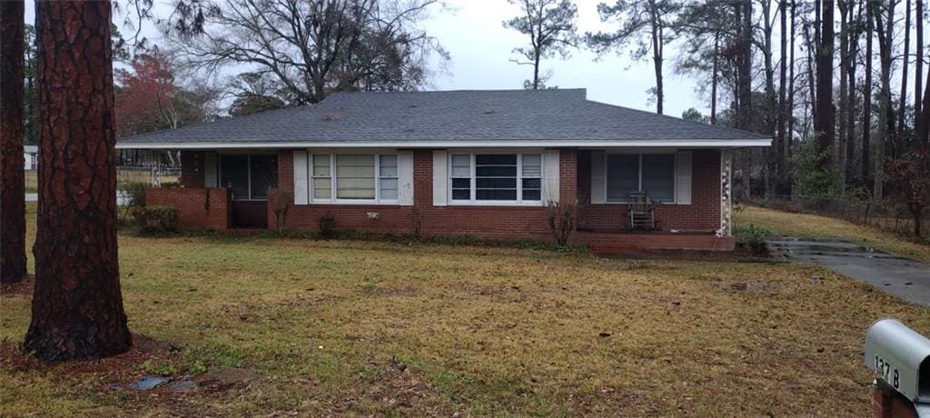 ranch-style house with a front lawn