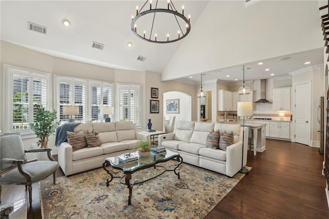 3005 Evelyn Ln, Alpharetta, GA 30004 - living room featuring recessed lighting, dark wood-style floors, a chandelier, high vaulted ceiling, and arched walkways