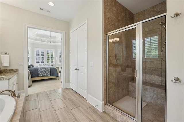 3005 Evelyn Ln, Alpharetta, GA 30004 - bathroom with a stall shower, vanity, connected bathroom, a relaxing tiled tub, and recessed lighting