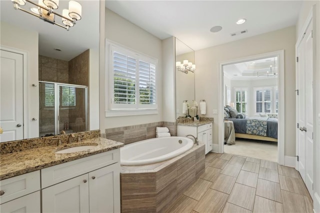 3005 Evelyn Ln, Alpharetta, GA 30004 - ensuite bathroom with a shower stall, vanity, a chandelier, a garden tub, and plenty of natural light