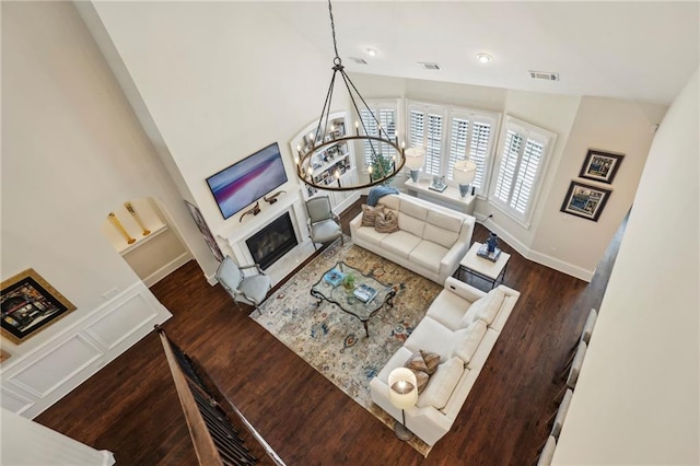 3005 Evelyn Ln, Alpharetta, GA 30004 - living room with a chandelier, wood finished floors, high vaulted ceiling, a glass covered fireplace, and recessed lighting