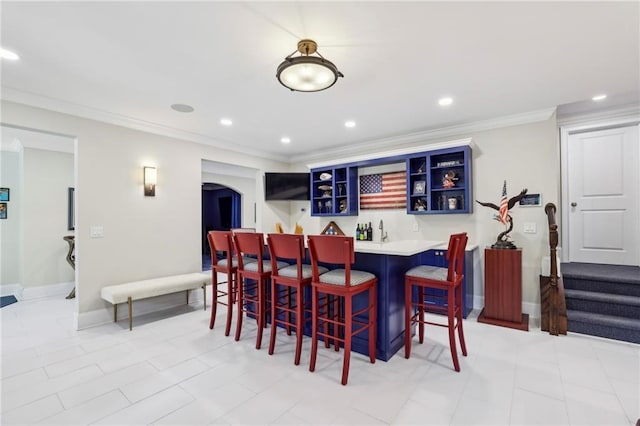 3005 Evelyn Ln, Alpharetta, GA 30004 - dining space featuring bar with sink, arched walkways, crown molding, recessed lighting, and stairs