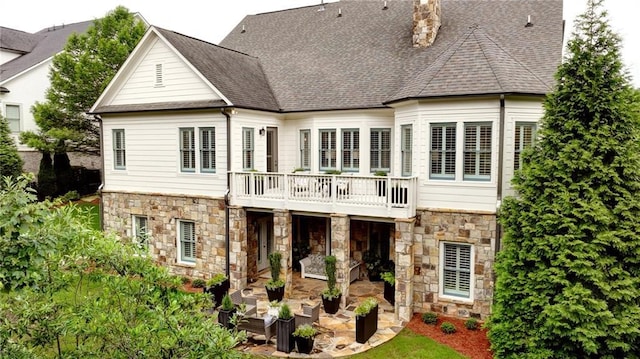 3005 Evelyn Ln, Alpharetta, GA 30004 - back of house with stone siding, a patio, a chimney, and roof with shingles