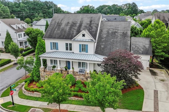 3005 Evelyn Ln, Alpharetta, GA 30004 - view of front facade with a standing seam roof, a porch, a garage, a metal roof, and stone siding
