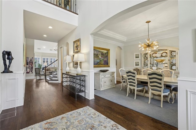 3005 Evelyn Ln, Alpharetta, GA 30004 - dining room with arched walkways, wood finished floors, a chandelier, ornamental molding, and stairs
