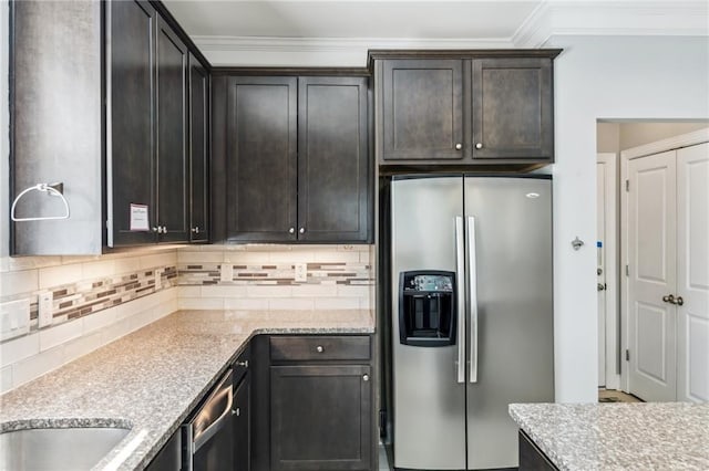 kitchen featuring tasteful backsplash, ornamental molding, stainless steel appliances, light stone countertops, and dark brown cabinets