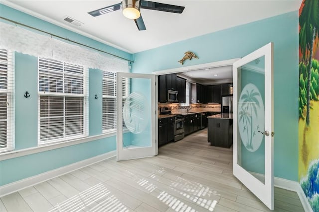 kitchen featuring french doors, ceiling fan, stainless steel appliances, and light wood-type flooring