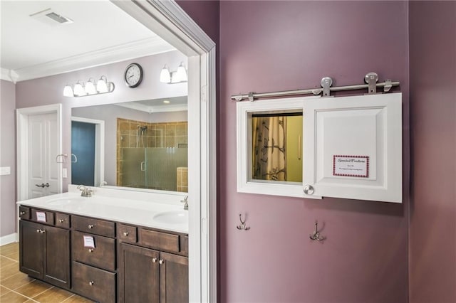 bathroom featuring vanity, tile patterned floors, ornamental molding, and walk in shower