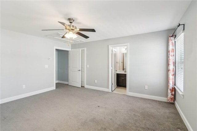 unfurnished bedroom featuring ensuite bathroom, light colored carpet, and ceiling fan