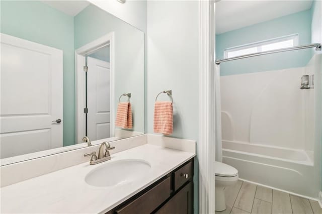 full bathroom featuring vanity, tub / shower combination, and toilet