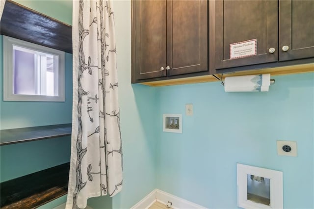 washroom with hookup for a washing machine, cabinets, and hookup for an electric dryer