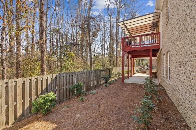 view of yard featuring a deck and a patio area