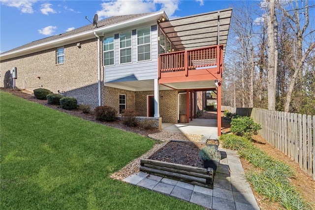 back of house with a yard and a patio