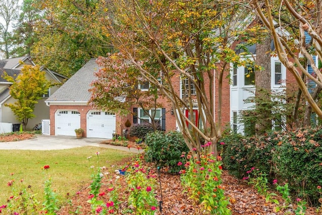 view of front of house with a front yard and a garage