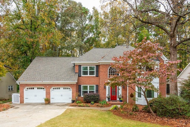 view of front of home featuring a garage and a front yard