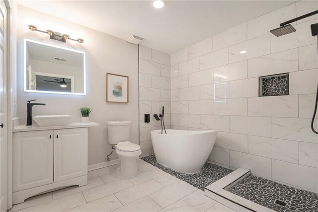 full bathroom with vanity, shower with separate bathtub, and toilet