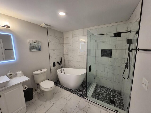 full bathroom featuring toilet, vanity, and shower with separate bathtub