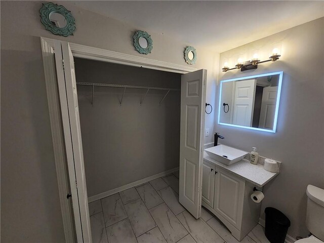 bathroom featuring vanity and toilet