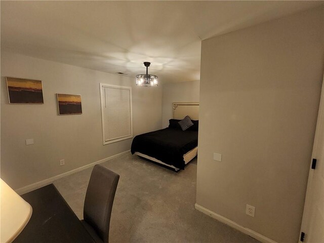 carpeted bedroom featuring a notable chandelier