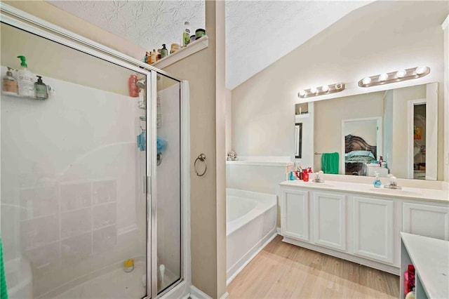 4161 Magnolia Glen Walk, Norcross, GA 30093 - ensuite bathroom with a stall shower, a garden tub, double vanity, and wood finished floors