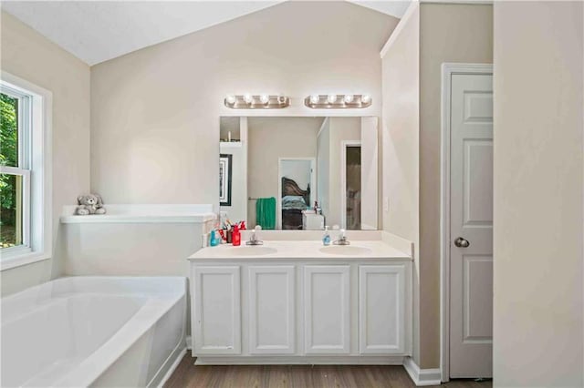 4161 Magnolia Glen Walk, Norcross, GA 30093 - ensuite bathroom with a bath, double vanity, and wood finished floors