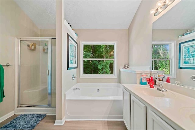 4161 Magnolia Glen Walk, Norcross, GA 30093 - bathroom with a bath, a stall shower, wood finished floors, double vanity, and a textured ceiling