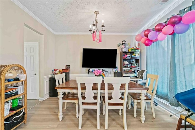 4161 Magnolia Glen Walk, Norcross, GA 30093 - dining room featuring wood finished floors, a chandelier, crown molding, and a textured ceiling