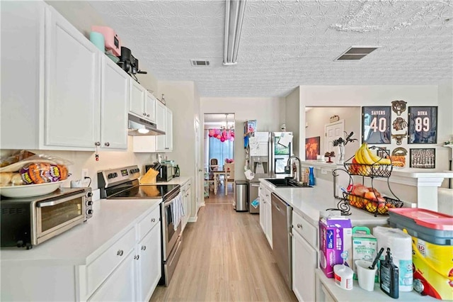4161 Magnolia Glen Walk, Norcross, GA 30093 - kitchen with stainless steel appliances, under cabinet range hood, a sink, light wood-style floors, and white cabinets