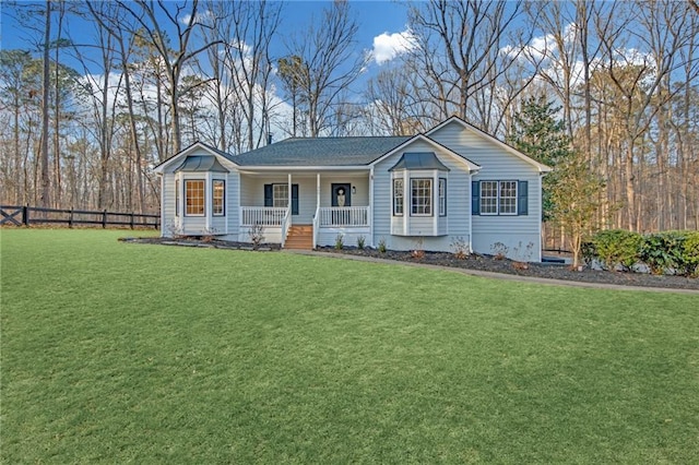 ranch-style house featuring covered porch and a front yard