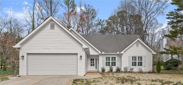 ranch-style home featuring a garage and driveway