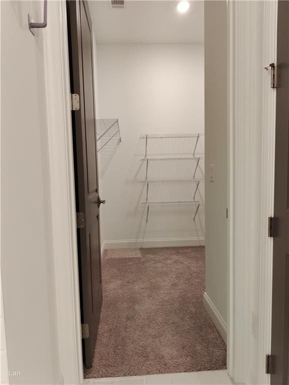 spacious closet with carpet floors and visible vents