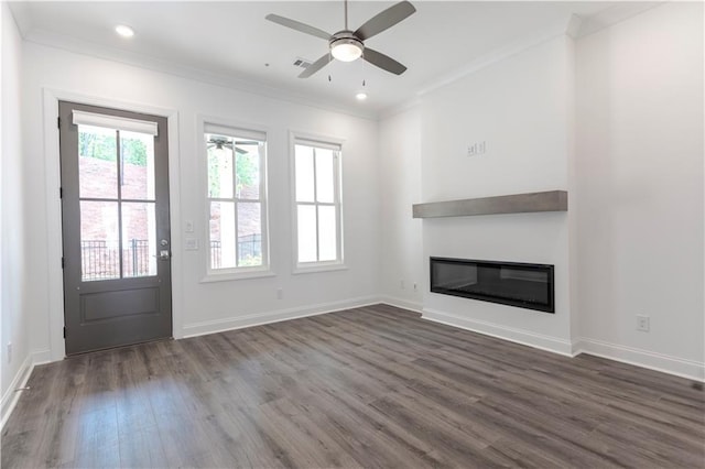 4948 Sudbrook Way, Peachtree Corners, GA 30092 - unfurnished living room featuring a ceiling fan, baseboards, a glass covered fireplace, ornamental molding, and dark wood-type flooring