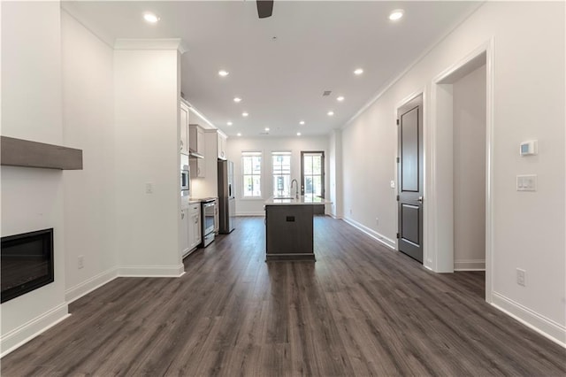 4948 Sudbrook Way, Peachtree Corners, GA 30092 - kitchen featuring a glass covered fireplace, stainless steel appliances, and dark wood-style floors