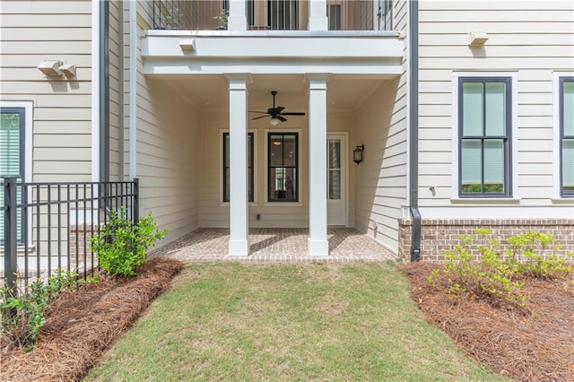 4948 Sudbrook Way, Peachtree Corners, GA 30092 - view of exterior entry featuring fence, brick siding, ceiling fan, a balcony, and a patio