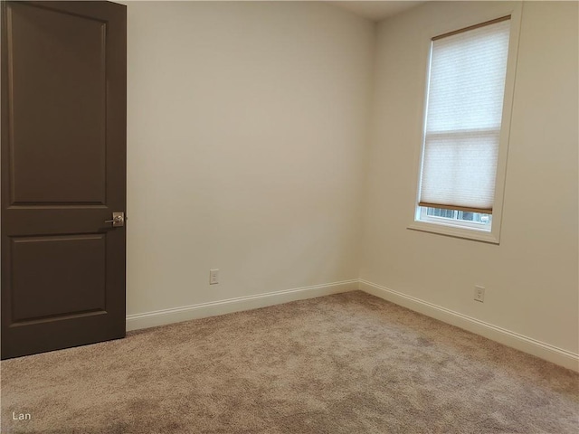 carpeted spare room with baseboards