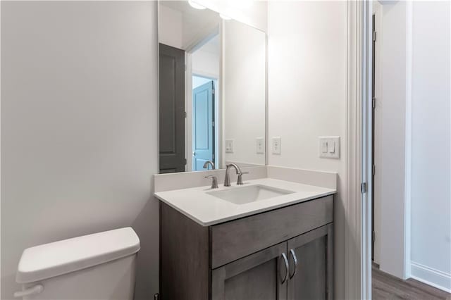 4948 Sudbrook Way, Peachtree Corners, GA 30092 - bathroom featuring vanity, wood finished floors, and toilet