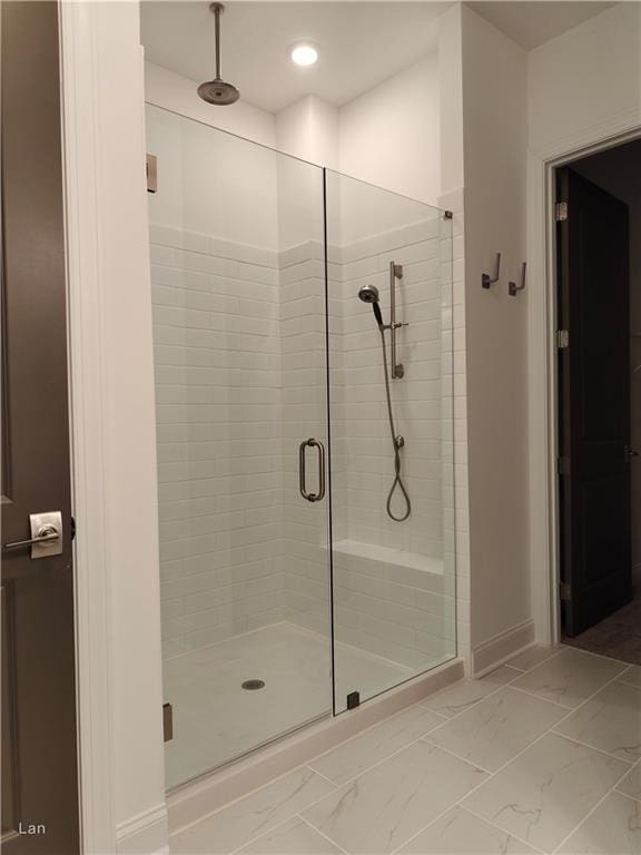 full bath featuring recessed lighting, marble finish floor, and a shower stall